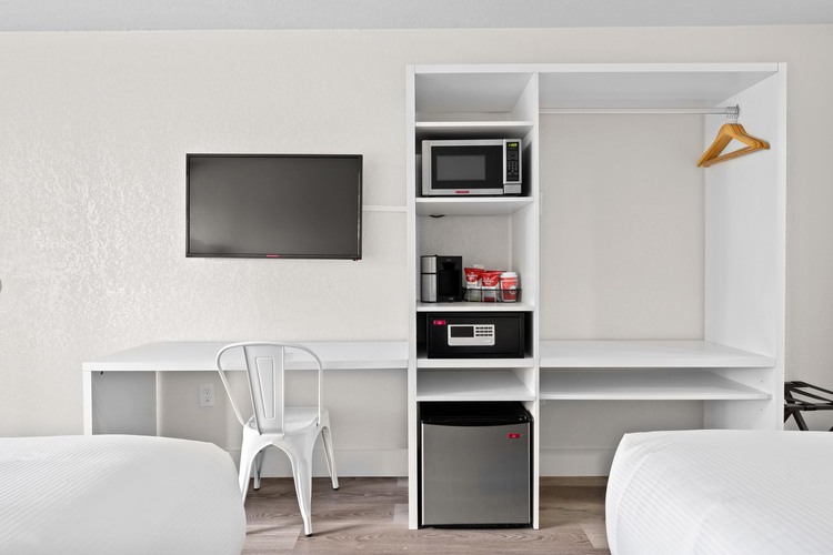 Room with TV, microwave, safe and mini fridge